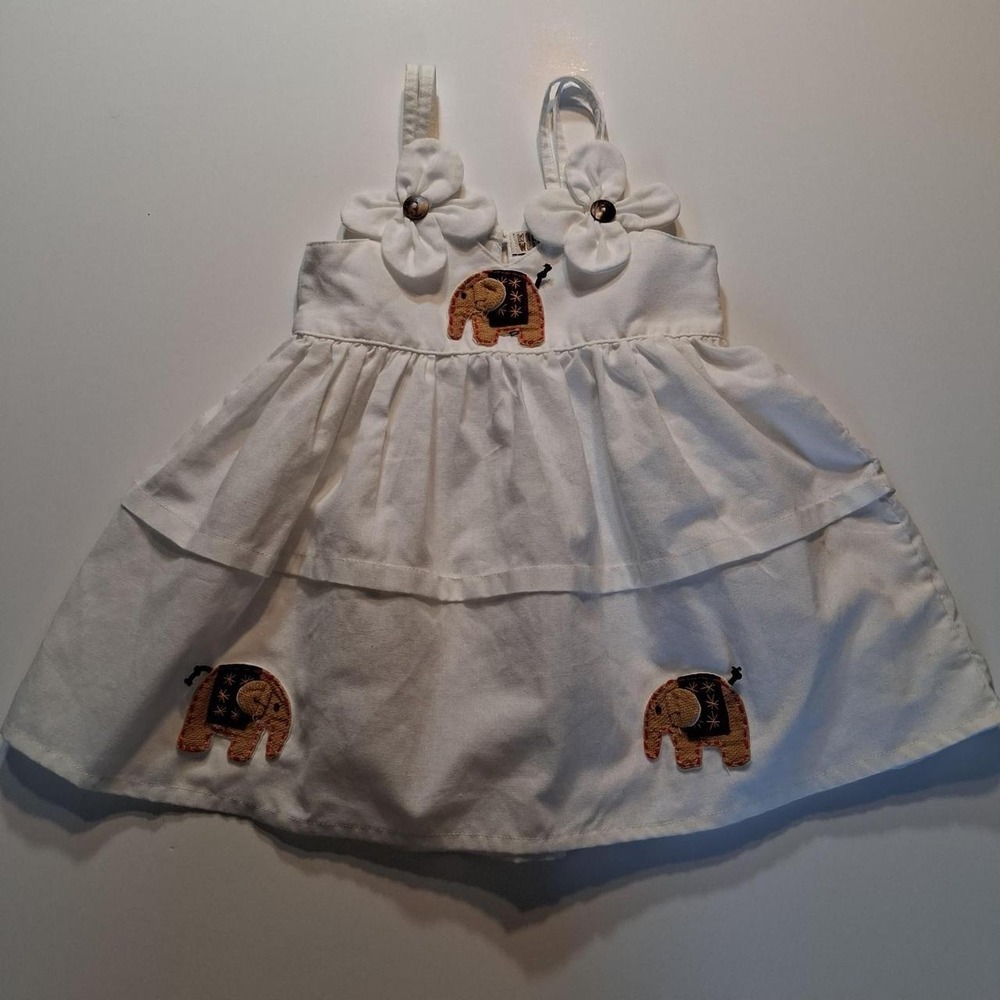 White baby dress with elephant applique and bow detail